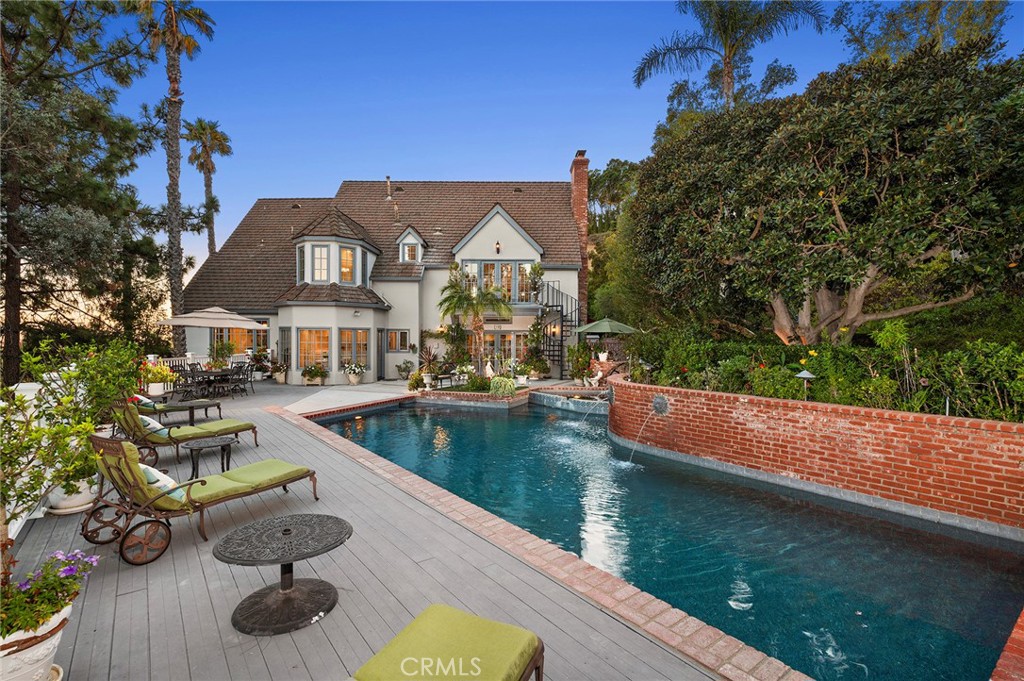 Nestled at the end of a quiet Cul-De-Sac, this elegant Cowan Heights estate offers breathtaking Panoramic Views, Privacy, and Refined Living on a generous lot in the largest unincorporated area of Orange County. A long private driveway with an electric gate leads to this tranquil home, combining seclusion with convenient access to the region's best amenities. Inside, freshly updated interiors feature new flooring and modern touches throughout, making this home move-in ready. The expansive living spaces are complemented by a chef-inspired kitchen, ideal for both casual family life and entertaining. A refrigerated wine storage room on the main floor adds a sophisticated touch for collectors and entertainers alike. Step into a backyard oasis designed for entertaining, featuring a recently Remodeled Pool and Spa with Waterfall Features, and a Built-in Barbecue and Grill area perfect for alfresco dining and gatherings. Enjoy Beautiful Hillside Views and Outdoor Serenity, with nearby Peters Canyon Regional Park offering hiking and biking trails. Large, upscale lots define the neighborhood—free from apartments or condos—creating a more rural, spacious atmosphere. Centrally located, the home is just 20 minutes from John Wayne Airport, 20 minutes to Disneyland, and under 30 minutes to Newport Beach, with easy access to the 5, 55, and 22 freeways. Shops, restaurants, and city amenities in Tustin and Orange are within a short drive, balancing convenience with privacy. This is a rare opportunity to enjoy a refined, private estate in a serene, rural-like enclave while staying connected to the best of Orange County.