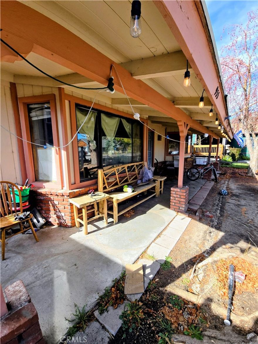 Looking to build sweat equity? This could be your opportunity. Tucked away on a quiet street beneath a canopy of mature trees, this home offers a spacious floor plan designed for easy living and room to grow. The kitchen opens to both the dining area and family room, creating a functional flow filled with natural light. Downstairs features two large bedrooms and a full bath, plus a separate laundry room and an attached two-car garage for added convenience. Upstairs, the private primary retreat features generous living space, a walk-in closet, and a walk-in shower. Step onto your own balcony and soak in panoramic views of the stunning Big Bear mountains. With beautiful views from both levels and solid bones ready for renovation, this property is a great deal for buyers looking to customize their mountain home. Bring your vision — this one won’t last!