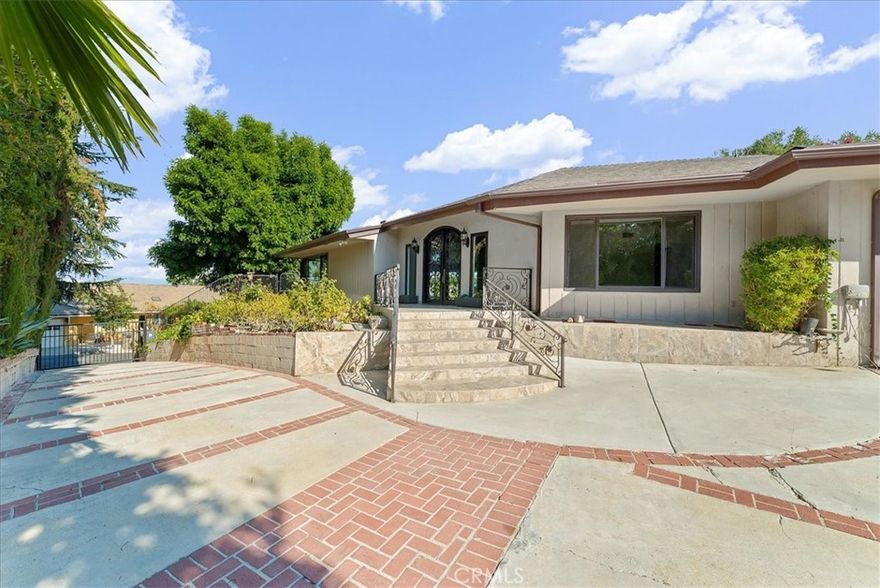Luxury Live Auction! Bidding to start from $1,800,000! Nestled in the prestigious Royal Oaks neighborhood of Encino, this single-story gated mid-century home sits on a generous 16,041 sq. ft. corner lot on a tranquil cul-de-sac. Offering 3,570 sq. ft. of living space, this property presents an exceptional opportunity for investors or developers. With breathtaking views, there is potential to remodel and upgrade the existing home, expand the outdoor space with a deck to further enhance the view, or even tear down and build a magnificent estate. The expansive open-concept great room seamlessly blends the living room, family room, and dining area, all featuring elegant porcelain tile flooring. The kitchen is designed with granite countertops and a spacious eating area. The home includes four bedrooms, all with hardwood floors, and three bathrooms. Two bedrooms share a Jack and Jill bath, while a separate fourth bedroom is conveniently located next to a ¾ bath. The primary suite boasts a walk-in closet and a spa-like bathroom with dual vanities and a sunken terrazzo tub. The private backyard, complete with a pool, provides the perfect setting for relaxation and entertaining. Ideally situated in the sought-after Lanai Road Elementary and Hesby Oaks Middle School districts, the property is also just moments from Ventura Boulevard’s vibrant shops and restaurants, with easy access to freeways and the Westside.