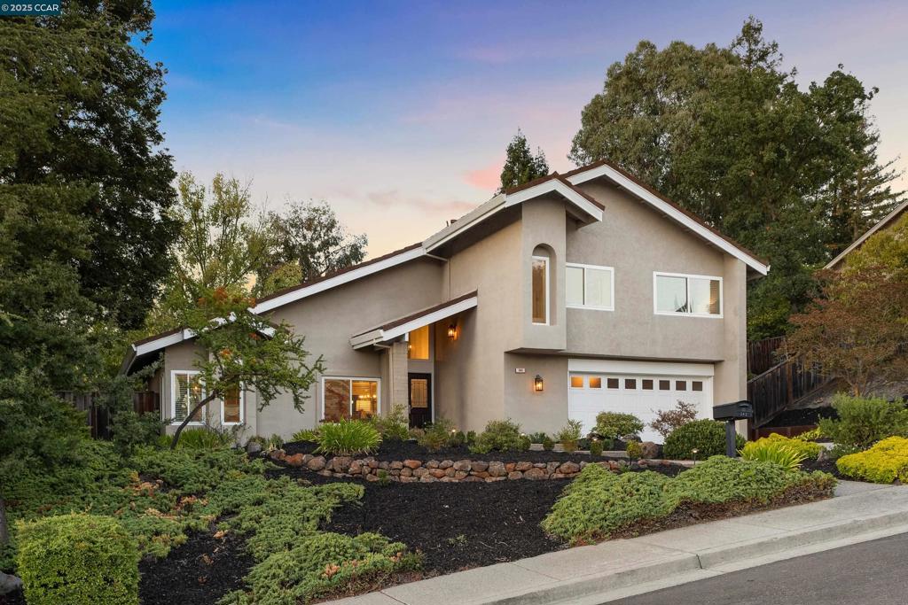 Situated on a premier street in a sought after community, this well-maintained 4 bed, 2.5 bath home truly checks all the boxes! The home welcomes you with a large front yard, a long driveway, and undeniable curb appeal. Step inside to find soaring ceilings in the light filled living and dining rooms-perfect for entertaining. The updated kitchen features solid surface countertops, ss appliances, and bar style seating. A breakfast area overlooks the inviting family room, complete with a beautiful fireplace and a built-in bar, ideal for hosting. The expansive primary suite boasts vaulted ceilings and a dedicated lounging area with serene views of the landscaped grounds. The remodeled primary bath showcases elegant cabinetry, updated countertops, a Jacuzzi tub, and abundant closet space. Additional bedrooms are well-sized, with ample storage and scenic views of the surrounding hills. The bathroom off the upstairs hallway is tastefully updated with designer finishes. The backyard is the crown jewel of this property—a true outdoor oasis. With its expansive paver patio, mature trees, park-like lawn, and partial views of the Las Trampas hills, it offers unmatched privacy and endless possibilities. Conveniently located close to town, parks and award-winning schools.