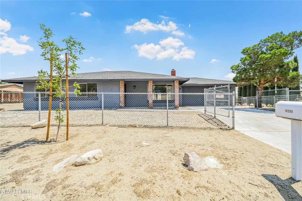This beautifully renovated home sits on a large, fully fenced lot and welcomes you with fresh interior and exterior paint that gives it a clean, modern look from the moment you arrive. Step inside to find brand new plank flooring throughout, complemented by stylish new light fixtures and updated plumbing fixtures that add to the home's move-in-ready appeal. The kitchen has been thoughtfully refreshed with newly painted cabinets, sleek new countertops, and all new stainless steel appliances, including a new sink and faucet—perfect for both everyday cooking and entertaining. The open dining area connects seamlessly to the kitchen, creating a functional and inviting layout. Both bathrooms have been updated with custom lighting, new faucets, and refreshed vanities, while the master suite offers dual closets and new hardware for a polished finish. The home is filled with windows that bring in beautiful natural light, and the cozy wood-burning fireplace adds warmth and character to the main living space. Outside, the entire lot has been cleaned and leveled, offering flat, usable space with RV access gates and chain-link fencing around the perimeter. The extra-large driveway provides plenty of room for parking, while the spacious patio slab and covered patio overlook the expansive backyard and allow you to soak in the beautiful views that surround the property. Whether you're enjoying the peaceful setting or entertaining guests, this home is ready for you to move right in. This is a rare offering in a great location—come see it today!