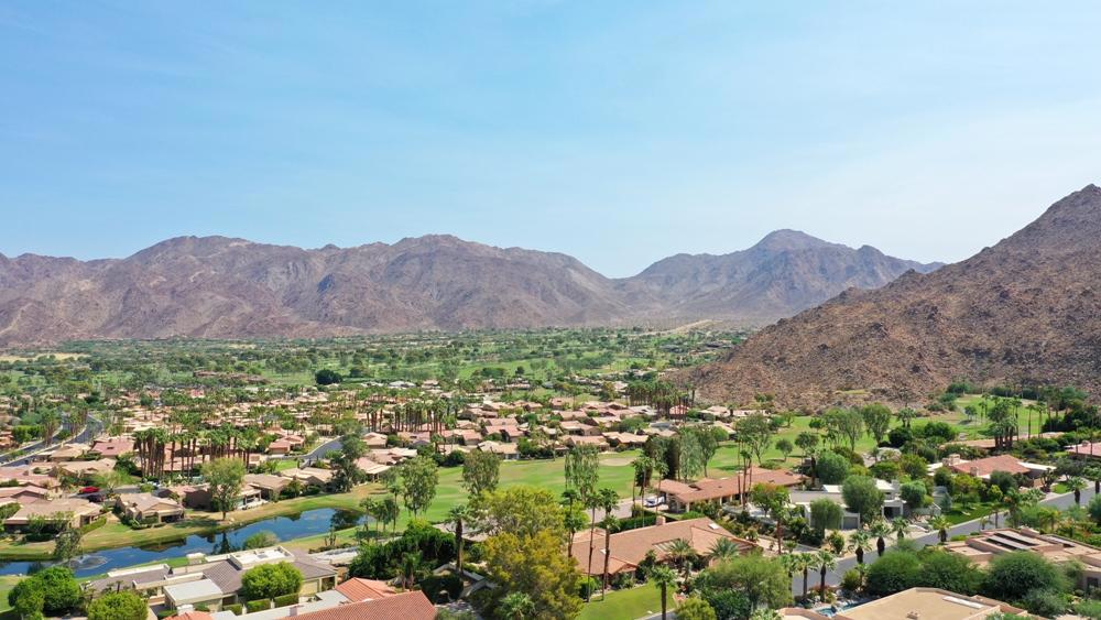 Elevate your vacation lifestyle at this stunning contemporary custom home located in a prestigious neighborhood of 20,000 sq. ft. lots behind the gates of the awesome Ironwood Country Club. You will be impressed even before stepping inside. The extraordinary entry to home boasts privacy and panoramic mountain views and a huge outdoor entertaining area -- custom water features, infinity saltwater pool, spa, outdoor kitchen, dramatic landscape lighting and mountain views. The backyard has another large entertaining space with a BBQ island, custom fire pit and more beautiful mountain views. That fun spot is surrounded with lush landscaping and lawn. The dramatic open floor plan is light filled and its walls of windows offer breathtaking mountain views everywhere you look. The great room with its fireplace, bar and large media center is open to the kitchen that offers casual eating at the breakfast bar or in the adjacent formal dining room with amazing views.The master bedroom wing includes an adjacent office with gorgeous built-in cabinetry while the guest bedroom wing is on the opposite side of house and hosts two additional bedrooms, one with private entry.Make this your HOLIDAY HOME!