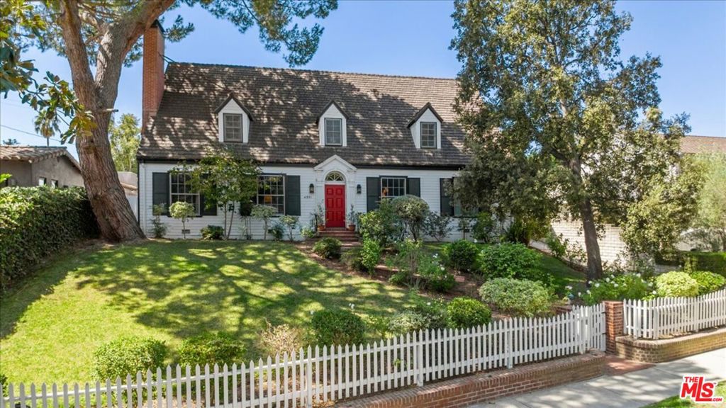 This elegant traditional home framed by a classic white picket fence resides above the street in the prestigious enclave of Toluca Lake. Professionally appointed with rich tones & touches throughout, this two story home exudes warmth, style & comfort. A formal entry connects the living room with fireplace & the dining room appointed with a chic chandelier while the spacious marble and stainless steel kitchen offers both a built in breakfast booth & a sitting area before a brick fireplace. Nearby is a convenient laundry room plus a home office and guest bedroom. Upstairs boasts a sophisticated primary suite with a vintage style clawfoot tub & sauna for a deluxe spa like experience at home. Two other bedrooms share another bathroom ideal for siblings or guests. Outside sliding French doors, a sprawling grassy lawn stretches across the thriving backyard before a sparkling brick lined pool and guest house - ideal for a home office or studio space. An array of top notch eateries, charming boutiques & grocery stores are blocks away as are two of the world's most iconic TV/film studios (Warner Brothers and Universal) - making this quaint area the perfect hybrid oasis blending glamorous Hollywood with small town America.