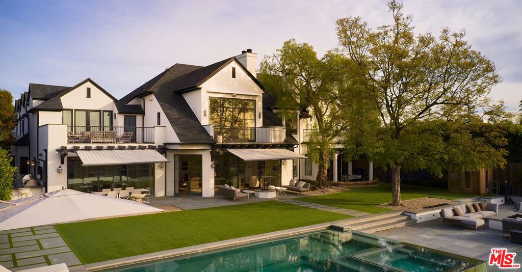Gated and set in a quiet cul-del-sac for consummate privacy, this unparalleled estate is truly in a class of its own, blending timeless elegance and modern luxury, while showcasing far-reaching views of the city and ocean. The architectural design incorporates a sense of overarching grandeur, with sweeping Euroline steel floor-to-ceiling windows, outdoor lounge terraces and viewpoints that highlight the endless vista. Warm and beautifully contemporary interiors have been highly curated into an incomparable palette of texture, color and space - each room with its own distinct personality, artisan detailing and bespoke millwork. The grand formal living room, featuring 150-year old French barn wood herringbone flooring, beams with an abundance of light and effortlessly flows into the formal dining and family room. The Poliform Chef's kitchen comes equipped with a large marble center island, top-of-the-line Wolf ranges and Sub-Zero appliances. The estate boasts 7 bedrooms, 8 bathrooms, an expansive guest wing, exquisite two-story library adorned by cathedral ceilings and art-nouveau inspired detailing, and an opulent billiard room with lounge and bar. The luxurious primary suite includes custom finishes, dual walk-in closets and en suite marble-clad bathroom with glass shower, soaking tub, and dual vanities. With panoramic outdoor views and expansive grassy grounds, the estate is an entertainer's dream complete with infinity pool, spa, outdoor kitchen, and even a hidden waterslide. Other notable features include a large motor court, 3-car garage, outdoor sauna and organic vegetable garden. Prime location, just moments from both Rodeo Dr and the studios in Burbank.