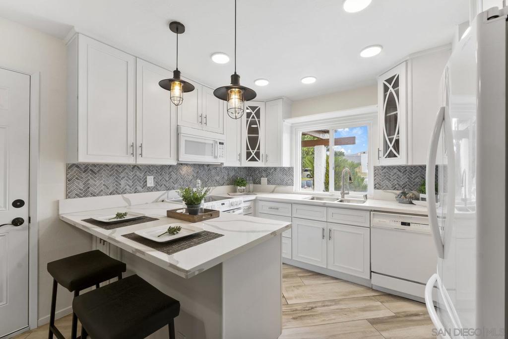 Move-In Ready Home in a Sought-after Single-Story Community! Welcome to Bostonia Gardens, a beautifully landscaped and peaceful enclave of just ten single-story homes. This charming and meticulously maintained residence blends comfort, style, and convenience in one inviting package. Step into a bright and open living area featuring luxury vinyl plank flooring, recessed lighting, and a large window with serene views of the community greenery. The spacious kitchen impresses with extended quartz countertops that double as a dining bar, matching white appliances (including refrigerator, electric stove, microwave, and dishwasher), a double sink, and tranquil views. The freshly renovated bathroom showcases stylish tile finishes, quartz counters, and a modern vanity. Enjoy seamless indoor-outdoor living with a large wraparound private patio, perfect for relaxing, gardening, or entertaining. A dedicated garden area and oversized exterior storage closet add to the home’s functionality. Additional highlights include dual-pane windows, newer A/C and water heater, and an attached one-car garage with built-in storage. Ideally located on a quiet cul-de-sac street, just minutes from the freeway, shopping, and restaurants, offering the best of convenience and comfort in a private gated setting.