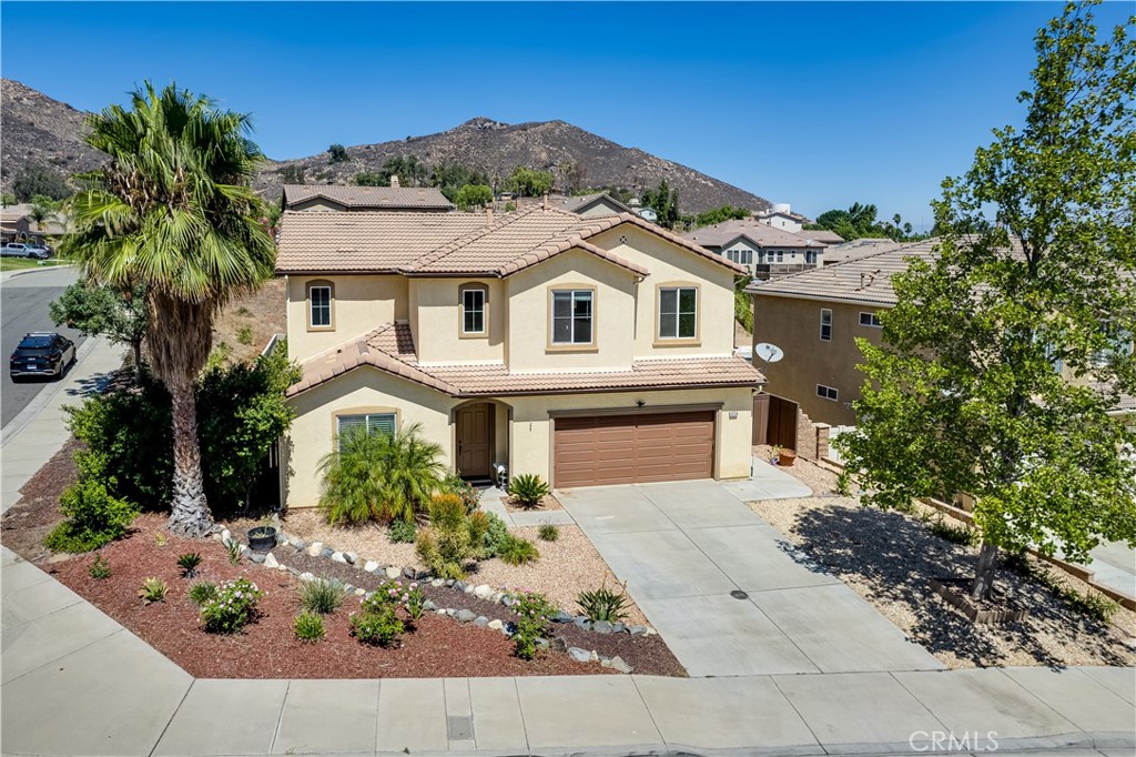 Welcome to 12179 Dewar Drive, Riverside, a spacious 5-bed, 3-bath home on a large corner lot with stunning mountain views. Built in 2010, this home offers over 2,300 sq. ft. of living space with a brand-new HVAC system, tiled flooring throughout, and high ceilings that create an open, airy feel.
The floor plan is designed for both comfort and flexibility with one bedroom downstairs and four bedrooms upstairs, including the primary suite. Upstairs you’ll find two bathrooms; along with a convenient laundry room with sink. The primary suite boasts a walk-in closet and private bathroom, while the additional bedrooms also feature generous closet space.
At the heart of the home, the extended kitchen offers a large island, modern counters, and abundant cabinetry, opening seamlessly into the living room with a cozy fireplace.
Outside, the quarter acre corner lot features a covered patio and plenty of space for entertaining, gardening, or simply enjoying the views. A 3-car tandem garage and oversized driveway provide ample parking and storage.
Conveniently located near the 15 and 91 freeways, this home is tucked away on a quiet cul-de-sac in the Alvord Unified School District near Hillcrest High, with shopping, dining, and parks just minutes away.