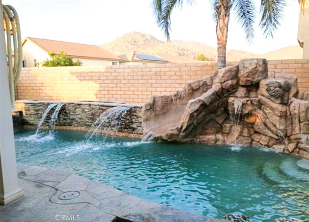 Your Own Private Resort-Style Retreat!
Welcome to this spacious and versatile 6-bedroom, 3-bathroom home designed for comfort, function, and flexibility. With high ceilings, an open-concept layout, and a/c units on each floor, this two-story home offers a true sense of space and ease.
Upstairs features 4 generous bedrooms, including a huge master suite with a large walk-in closet, soaking tub, separate shower, and dual sinks. A large den above the garages is ideal as a movie room, game space, or creative studio.
Downstairs, two private-entry bedrooms have been reconditioned into a junior studio with a full bathroom and private patio access. This area is currently rented for $1,500/month, providing valuable rental income or multigenerational living options. One of the original three garages has also been converted into a cool and fresh work-from-home space—perfect for remote professionals or creative use. All modifications can be easily reversed to return to the original floor plan if desired. Outdoor living shines here with a covered patio, ceiling fans, lush palm trees, and a rock formation with a slide into the pool and Jacuzzi—your very own backyard oasis! Additional features include: Curtain shutters throughout, Solar panels under contract to purchase (buyer to assume loan, approx. $265/month, with long-term energy savings), Ceiling fans, Fireplace, pantry, and ample kitchen cabinetry
Mixed flooring: soft carpet, tile, and modern plank. Low HOA fees, Prime location near schools, shopping centers, and multiple freeway options
This home is ideal for those seeking space, comfort, and potential income. Visit and see the possibilities—make this home yours today!
Motivated seller — schedule your private tour now!