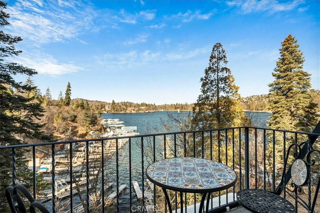 Lakefront in the desirable Palisades neighborhood, with expansive lake and mountain views from every room! Come experience mountain-lake life in Southern California’s most prestigious four-season, private lake community just 90 minutes from LA and OC. This home has been tastefully updated with an open floor plan featuring updated kitchen with SS appliances that seamlessly connects to dining room on one side and large living room with stone fireplace on the other with direct access to main floor deck. The upper floor offers 3 generous bedrooms including master en-suite with soaking tub and balcony overlooking the lake. The lower level offers a fourth bedroom family/game room and additional bathroom with direct access to lower deck. Home sits right on the ALA trail and is just a short stroll to the ½ dbl dock that is included. Recent updates include roof, windows and doors, interior wood flooring, maple cabinetry, granite counters & SS appliances. Home has parking deck for up to 4 cars, central A/C and is move-in ready. Come start making memories today!