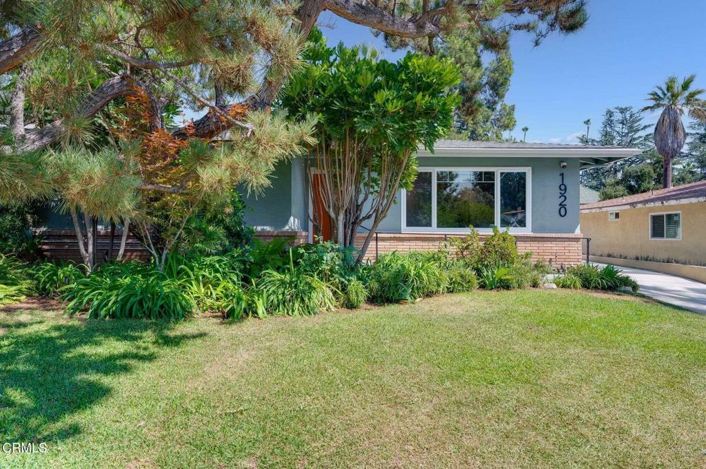 Located on a quiet street in Altadena, this once traditional home has been taken up a couple notches design-wise. The new swanky interior features a stunning fireplace with built-in cabinetry, a frame tv and custom lighting, setting the mood for entertainment. New wide plank oak floors seamlessly carry you into the open kitchen and dining room, which grabs your attention with a beautiful waterfall kitchen island, marble backsplash, and an abundance of space for both the budding chef and family gatherings to enjoy. The party can continue out to the cozy patio, or to the beautifully lush backyard with mature foliage and a quaint secondary patio. The interior of the home offers 4 bedrooms and 3 bathrooms, 2 of which are en-suite, including the master with a large walk-in closet and a beautifully transformed bathroom with dramatic tile work throughout. This move-in ready home is sure to grab your attention!