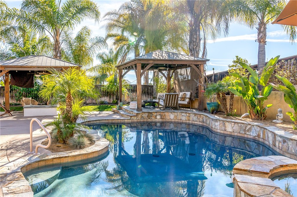 Are you looking for a home that has it all? Look no further! This 5 bedroom 4 bathroom home has been tastefully remodeled with custom designs by Joseph DeCasperis Designs. 3,288 square feet of living space with custom touches throughout. Solar is owned. RV Parking. Casita/She Shed. No Rear Neighbors. Breathtaking views from the front and back. Formal Living room currently being used as a music room. Bedroom and full bathrom downstairs. Dining room with access to courtyard with fireplace. Family room with custom tiled wall, built in fireplace, reclaimed wood mantle, updated recessed lighting and massive wood ceiling fan. The kitchen was gutted and totally redesigned by custom designer. Built in appliances, massive island with reclaimed wood island and honed leather finished quart counter top. Farm house sink, built in microwave, beverage fridge, metal hood vent and wood shelves. Master Bedroom suite complete with full master bathroom, large separatedWIC and a balcony with the most amazing sunset views. The best part, no rear neighbor! Jr. Master Suite with full bathroom. 2 additional guest bedrooms with jack and jill bath and massive loft, The backyard is like an oasis. Salt Water pool and Spa. Outdoor kitchen with Fire-magic grill, fire pit, 2 custom pergola seating areas. Landscaping is mature including multiple citrus trees, 2 avocado trees, fig tree and palm trees. 3 sheds for ample storage. Low taxes, Low HOA. Temecula School district. Seller NEVER intended on moving. Renovation costs exceed $350K. Call today for your private showing.