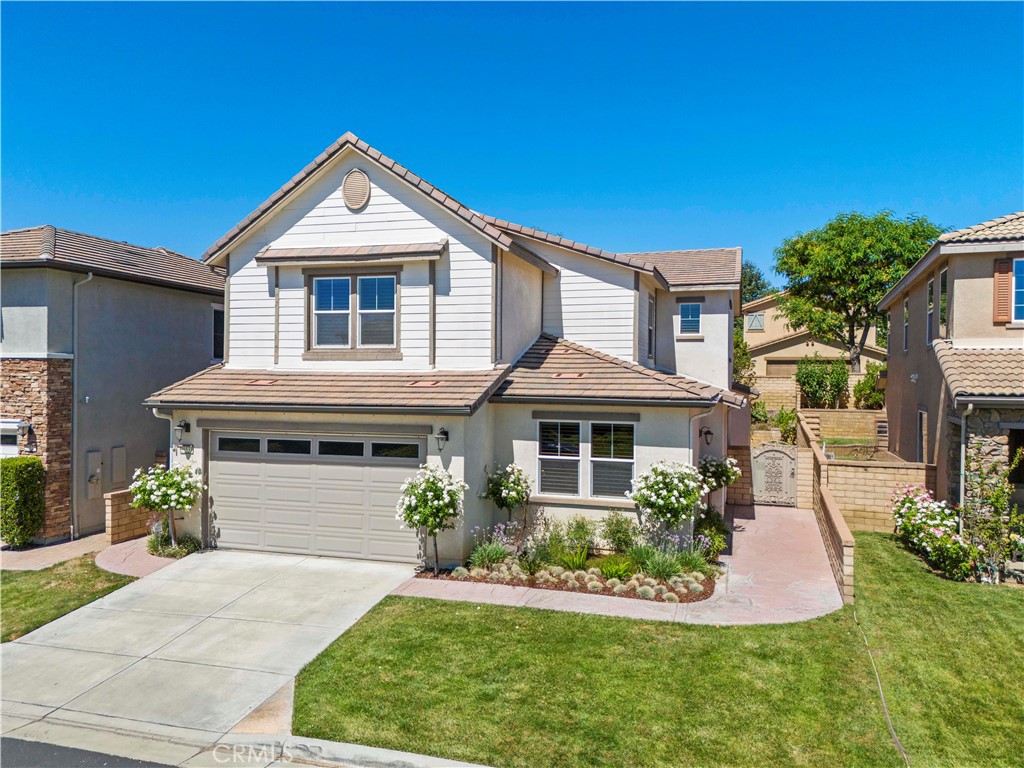 You will love this hidden gem tucked inside the desirable neighborhood of West Creek, Valencia this upscale Patina 4-bed, 3-bath + loft home offers over 3,060 sqft of upscale living.
Freshly painted and move-in ready, this home features a flexible floorplan with a first-floor bonus room (perfect for a 5th bedroom, home office, or playroom), a spacious loft, and a 3-car garage. Thoughtful upgrades include rich wood floors, upgraded tile, plantation shutters, dual-zone A/C, surround sound, tankless water heater, gas fireplace, and ceiling fans throughout.
The gourmet kitchen is ideal for entertaining, boasting GE Monogram appliances, an eat-in island, butler’s pantry, full-wall pantry, built-in tech center with desk, and a separate mudroom. Upstairs, the open loft separates the bedrooms for added privacy.
Retreat to the luxurious primary suite featuring dual vanities, a soaking tub, walk-in shower, and an expansive custom-built closet with a private dressing area. The three additional bedrooms all include walk-in closets and share a dual-vanity bathroom.
Step outside to your lush and private backyard oasis—complete with a covered patio, mature landscaping, and plenty of room to relax or entertain.
Located near scenic walking trails and just minutes from top-rated schools, shopping, dining, parks, clubhouse, and three community pools—this home offers the best of resort-style living in one of Valencia’s most sought-after neighborhoods.
Bring the whole family, your furry friends and start making unforgettable memories. Welcome home!