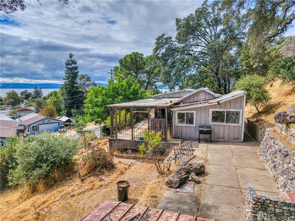Cozy 1 bedroom, 1 bathroom home with 684 sq ft of living space and endless potential! Enjoy stunning views of Clear Lake and the iconic Lucerne Castle right from the large front deck — perfect for relaxing or entertaining. This fixer is ready for your vision, whether you’re looking to create the perfect lake retreat or a smart rental investment. Situated on 4 parcels, the property offers privacy all around plus plenty of space to spread out. Off-street parking behind a locked gate with room for two cars. Extras include a shed and a chicken coop for those who love a little homestead charm. With some TLC, this property could truly shine!