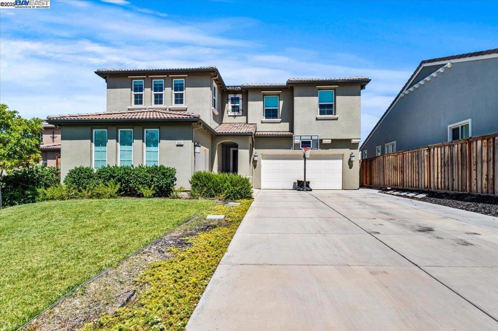 Tech-forward and energy-efficient 5-bed, 3.5-bath home with full first-floor ADU in Tracy Hills. Ideal for multigenerational living or income potential, the ADU includes a private entrance, kitchenette with stove/sink/microwave, living room, bedroom, and full bath. Built by Shea Homes on a premium oversized lot, this property features owned solar (16 panels), a 20kWh Sonnen battery for whole-home backup, and EV charger-ready. Smart home infrastructure includes Cat5 ethernet in all rooms, ceiling-mounted PoE WiFi beacons, Ring doorbell, app-controlled HVAC and lighting, and a dedicated network closet. Dual-zone HVAC, upgraded insulation, whole-house fans, soft water system, and reverse osmosis drinking water reduce energy use and monthly costs. Outdoors: $100K custom heated pool/spa, pergola, ForeverLawn turf with safety padding, play zone, smart irrigation, and California Room patio. Chef’s kitchen with GE Café appliances, waterfall quartz island, 6-burner cooktop. 3-car epoxy garage. Walk to Corral Hollow K–8 school, parks, and market. 5 mins to I-580/ACE train.