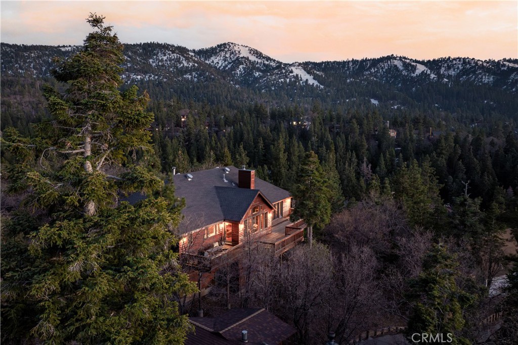 Incredible views of Bear Mountain Ski Resort and Big Bear Lake! Relax on the oversized deck with panoramic views of all that Big Bear has to offer. This spacious home won't fail to impress with quality workmanship throughout. The top level includes 2 bedrooms including an en suite, along with the open-plan Kitchen and Living Room, all with incredible views! The master bathroom includes an oversized shower and jetted tub with Bear Mountain Ski Resort's famous "Geronimo" run just outside your window. Other notable features include central forced air conditioning and heat, a bonus bunk room, a game room, oversized 2-car garage, a generator, and more! Adjoining 12,865 square foot lot is available to buyer of home for $150,000. The two lots combined would be 29,443 square feet. Don't miss this one!