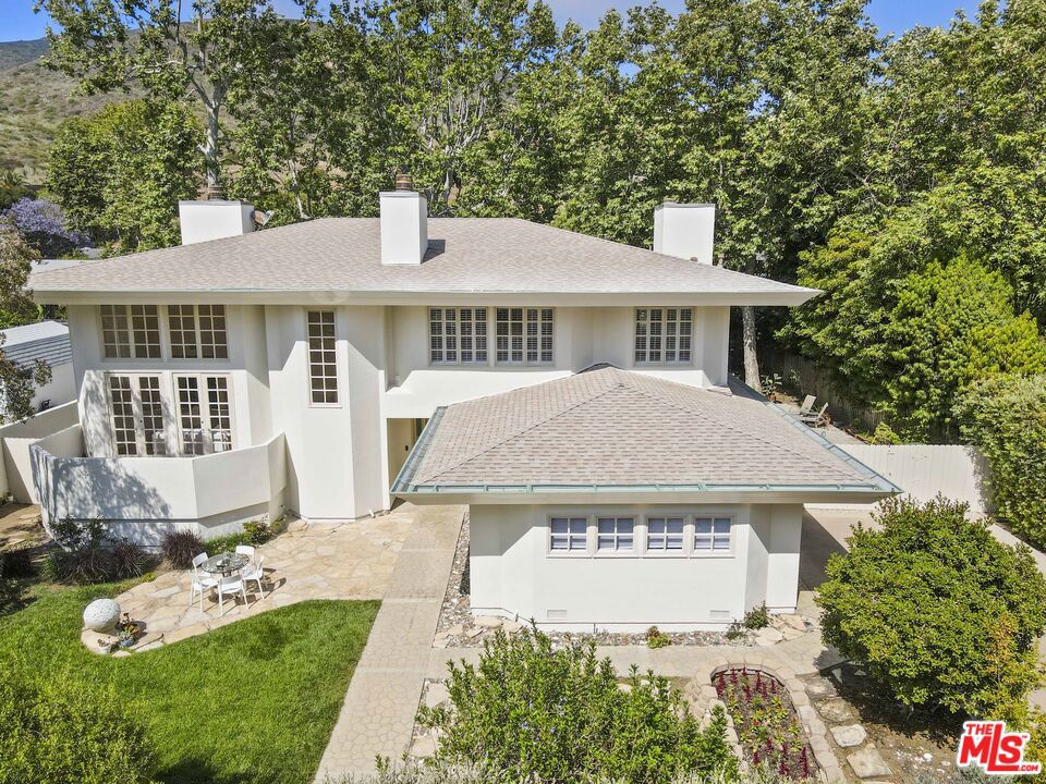 Located in one of Malibu's true neighborhood communities, this 5-bedroom, 5-bath home in Malibu West offers 3,565 sq ft of light-filled living space and access to exceptional amenitiesincluding a private beach club, tennis and pickleball courts, and a 24-hour guard-gated entrance. The neighborhood also features gated access to a pathway leading directly to Morning View Drive, offering convenient access to Malibu Middle and High School without needing to cross Pacific Coast Highway. Residents enjoy a strong sense of community, with nearby access to Trancas Market, Trancas Canyon Park, and Malibu's iconic beaches. The two-story layout offers a dramatic living room with soaring windows that flood the space with natural light. The open kitchen and dining area connect seamlessly to a flat, gated backyard ideal for outdoor living and entertaining. Additional main-level spaces include a comfortable family room, a media room, and a private en-suite bedroom, perfect for guests or flexible use. Upstairs, you'll find four additional bedrooms, including an updated primary suite featuring hardwood floors, a walk-in closet, soaking tub, and separate shower. The beautifully landscaped front and back yards are filled with mature fruit trees, raised garden beds, and ample space for gatherings. The generous driveway provides plenty of parking, including room for an RV. This is a rare opportunity to experience the lifestyle and amenities that make Malibu West truly special.