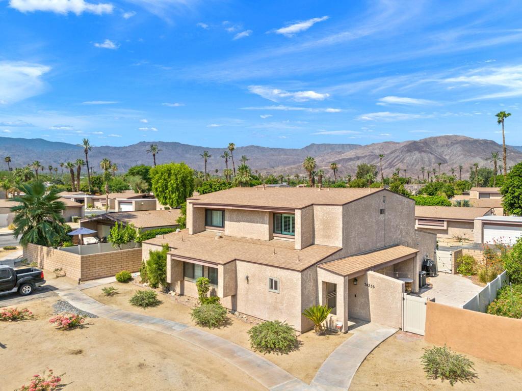 Quietly tucked at the back of gated Portola Del Sol, this light‑filled end‑unit townhome offers about 1,344 sq ft of stylish living with resort perks in the heart of Palm Desert. Vaulted ceilings, new LED lighting, fresh neutral paint and plantation shutters frame peek‑a‑boo mountain views. The updated kitchen boasts sleek Euro cabinets, modern kitchen appliances, quartz counters, mosaic backsplash, a breakfast bar and open sight lines to dining and living areas. Upstairs you'll find two roomy bedrooms sharing an elegant three‑quarter bath; downstairs a flexible den or office sits beside another remodeled three‑quarter bath and can become a third bedroom. Comfort is boosted by dual‑pane windows, newer HVAC, extra storage and an attached two‑car garage with laundry. Sliding doors open to an oversized, low‑care patio finished with stamped concrete and gated side access, ideal for entertaining, grilling or pets. A low HOA covers cable, high‑speed internet, water, trash, exterior paint, roof, plus two pools and spas, tennis, pickleball, greenbelts and guest parking. Live minutes from El Paseo shops and dining, Civic Center Park, McCallum Theatre, College of the Desert and top Desert Sands schools. A true turn‑key retreat for full‑time living, seasonal enjoyment or wise investment.