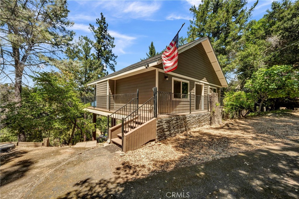 Charming Re-Imagined Cottage with Golf Course Views in Exclusive Buckingham! Tucked away off the road and surrounded by nature, this beautifully remodeled two bedroom, one bath home offers the quintessential blend of comfort, style, and serenity. Completely rebuilt from the ground up to modern code—including energy efficiency upgrades and a full fire sprinkler system—this property is both thoughtfully enhanced and safety-minded, with multiple damaged trees removed over the years to reduce fire risk and support peace of mind. Inside, an open floor plan is filled with natural light and complemented by a stylish spiral staircase leading to a versatile bonus loft—ideal for storage or even more sleeping space. An enclosed laundry room provides additional storage as well and adds everyday convenience. Expansive windows showcase picturesque views of the Buckingham Golf Course and a nearby pond, seamlessly blending indoor and outdoor living. High-quality finishes throughout add warmth and character, while sliding glass doors open to a spacious wrap-around deck— ideal for morning coffee, evening relaxation, or entertaining with nature as your backdrop. The landscaped grounds feature an in-and-out asphalt driveway, reinforced retaining walls, and a concrete pad providing additional level parking. A paver stone stairwell offers convenient entry to the lower portion of the property. As part of the Buckingham HOA, you’ll enjoy the use of a private boat launch, beach, dock, and clubhouse. With quick access to the nine hole golf course and Frisbee golf, this turnkey Buckingham gem is perfect as a peaceful full-time residence or a rejuvenating weekend escape—offering privacy, natural beauty, and modern convenience all in one.