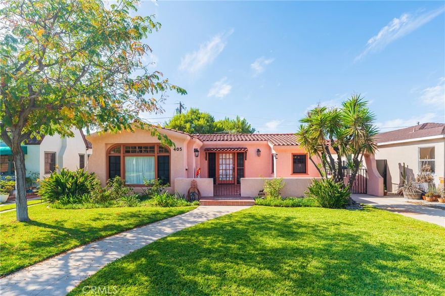 This stunning Spanish Revival home rarely comes to market, set on a gorgeous, quiet street filled with unique custom historic properties in a prized part of the Anaheim Colony Historic District. The vintage elegance inside shines with original architectural details: soaring coved ceilings, a gas fireplace, and expansive room sizes, complemented by the home's hardwood floors, built-in bookcases, and dramatic arched front window. Hosting is easy with the spacious dining room, featuring beautiful pocket French doors to the living room and an exterior French door leading to the front porch for optimal flow. The kitchen has been tastefully updated with real oak cabinets, a pantry, tiled counters, and a fabulous breakfast nook with built-in benches. Out back, a French door leads to a picturesque yard with a covered patio and mature trees that filter the afternoon sun, keeping the house cool. Both bedrooms are large with walk-in closets, and while vintage, the home enjoys the essential modern upgrade of central air and heat, plus a very long tandem garage perfect for two cars or a generous workshop. This home may be eligible for the Mills Act program through the City of Anaheim where the new owner may be able to save up to 60% off of their property taxes.  Location is key: you're just blocks from beautiful Pearson Park (duck pond, courts, events) and a short distance to the vibrant dining and entertainment of the Center Street Promenade and Packing District, with the 5, 91, and 57 Freeways minutes away. This home truly is the whole package.