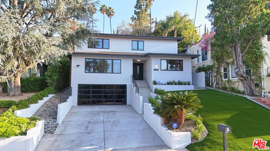 Nestled South of the Boulevard in prime Sherman Oaks, this completely remodeled contemporary 4-bedroom, 3-bathroom residence offers a seamless blend of modern elegance and comfort. The open-concept living room, highlighted by a wood-burning fireplace, flows effortlessly into the dining area with Fleetwood sliding glass doors opening to a tranquil, landscaped backyard.The gallery-style chef's kitchen features top-of-the-line stainless steel appliances, custom cabinetry, and a farmhouse sink with views of the lush greenery. The main level includes a bedroom and a full bathroom, ideal for guests or a home office. Upstairs, the primary suite offers a spa-inspired bathroom and a custom walk-in closet. Two additional bedrooms complete the upper floor, each bathed in natural light. The private backyard is beautifully designed with hardscape, mature landscaping, and a peaceful pergola -- perfect for entertaining or quiet relaxation. A true turn-key retreat, this home exemplifies sophisticated California living and is ready for its next discerning owner.