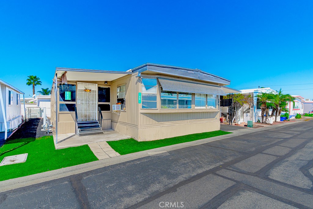 Welcome to this charming and affordable 2 bed and 2 bath home located in Devonshire Downs 55+ serene home park community! Primary bedroom is super spacious and features a full generous bathroom. This manufactured home comes with an open living space with a wide dining area and breakfast bar. Also, as a plus, the home does have an amazing and spacious sunroom right on the side of the manufacture home that can be used as storage or many more possibilities. Patio also comes with a spacious shed for storage. As if this wasn't enough, the community offers great amenities such as a sparking pool, a relaxing clubhouse and a billiard room. Conveniently situated near shopping, dining, casinos, and golf courses!! This home also offers easy access to both desert and mountain getaways. Just a drivable to distance to Palm Springs, Los Angeles, San Diego or Orange County!!Scheduled your private showing today!!
