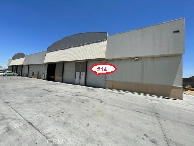 Multi-tenant mixed use Industrial Property has end cap unit 14 (2,000 sf). It has one ground level roll up doors and warehouse space. Asking rent $2,000/month + utilities. Located in Industrial Zone area. Open floor plan. Ideal for warehouse, auto repairs, etc. Paved road access.