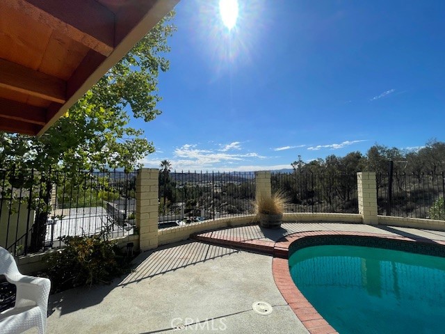 **Welcome to your hillside retreat with breathtaking panoramic views of Valencia and the Santa Clarita Valley!**
This beautifully maintained 2-bedroom, 2-bath home offers a lot size of 9,471 sq. ft. and 1,080 sq. ft. of living space that feels even larger thanks to its open, light-filled floor plan. From the moment you enter, you’re greeted by direct views of the sparkling pool, spa, and stunning backyard scenery—an entertainer’s dream.
The remodeled kitchen features an island breakfast bar, perfect for casual dining and entertaining. A spacious living room invites gatherings, while the home’s pride of ownership shines throughout. **Energy-efficient leased solar adds to the home’s appeal and helps offset utility costs.** The beautifully landscaped front yard and attached garage enhance the curb appeal.
Situated on a private and fantastic hillside lot with gorgeous views, this property is located in a wonderful neighborhood close to schools, dining, and shopping. It’s just 10 minutes to the 5 and 14 freeways, offering an excellent commuter location.
**This light and bright pool home perfectly blends comfort, charm, and convenience.**