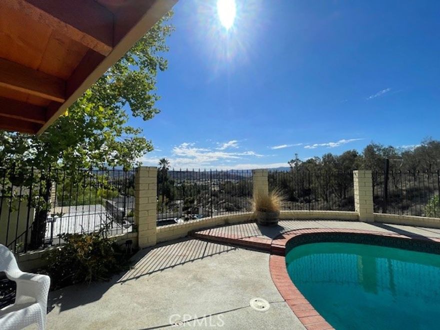 **Welcome to your hillside retreat with breathtaking panoramic views of Valencia and the Santa Clarita Valley!**
This beautifully maintained 2-bedroom, 2-bath home offers a lot size of 9,471 sq. ft. and 1,080 sq. ft. of living space that feels even larger thanks to its open, light-filled floor plan. From the moment you enter, you’re greeted by direct views of the sparkling pool, spa, and stunning backyard scenery—an entertainer’s dream.
The remodeled kitchen features an island breakfast bar, perfect for casual dining and entertaining. A spacious living room invites gatherings, while the home’s pride of ownership shines throughout. **Energy-efficient leased solar adds to the home’s appeal and helps offset utility costs.** The beautifully landscaped front yard and attached garage enhance the curb appeal.
Situated on a private and fantastic hillside lot with gorgeous views, this property is located in a wonderful neighborhood close to schools, dining, and shopping. It’s just 10 minutes to the 5 and 14 freeways, offering an excellent commuter location.
**This light and bright pool home perfectly blends comfort, charm, and convenience.**