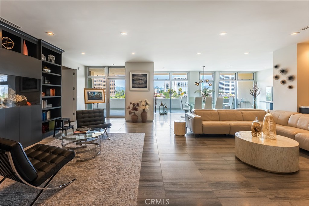 Sleek, modern, and tastefully appointed, this luxury high-rise residence offers sweeping 180-degree views of the city. Featuring 2 bedrooms and 3 bathrooms, the home is rich with premium upgrades and stylish designer touches throughout. The open-concept layout flows effortlessly from the formal entry into a spacious, sunlit living area, enhanced with a newly added fireplace framed by elegant stonework. Floor-to-ceiling double-pane windows line the entire living space, filling the home with natural light and offering direct access to an oversized balcony. The chef’s kitchen includes top-of-the-line appliances and custom cabinetry, and opens to the main living areas—perfect for entertaining. A nearby laundry room adds convenience with extra pantry storage and a discreet service entrance. Additional highlights include a custom-built bar with wine fridge, a flexible office or reading nook, and a luxurious primary suite with a spa-inspired bathroom, extensive closet space, and a dedicated dressing area. With full-service amenities such as pool, gym, valet, recreation area and security. this is a rare opportunity to own a refined, turnkey residence in a prime location.