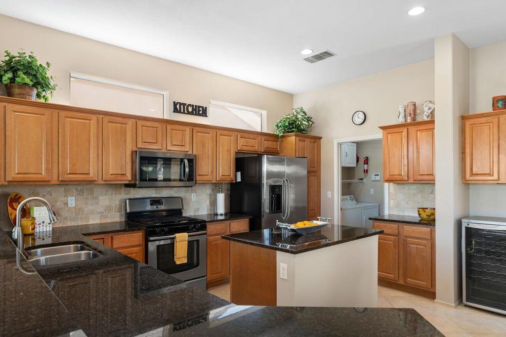 Beautiful Morocco model with 2 Bedrooms, Office and detached guest house on a premium fairway lot offering wide golf course views! This home features raised-panel cabinets, stone-look tile flooring, 10' ceilings, transom windows, and custom window treatments. The kitchen includes a large island and granite countertops, ideal for both everyday living and entertaining. Detached guest house includes a wet bar and refrigerator, perfect for visitors or a private workspace. Extended 4' garage provides additional room for storage. Located close to the Shadow Hills Clubhouse in a sought-after 55+ community. Sun City Palm Desert is a premier gated and patrolled resort-style community spanning 1,600 acres, renowned as the 'Best in the Desert' for its exceptional amenities and vibrant lifestyle. The community boasts 25 lakes and waterfalls, creating a tranquil environment amidst scenic beauty. For golf enthusiasts, two 18-hole courses feature recycled water irrigation and advanced water-saving systems, complemented by a driving range, pro shops, chipping and putting practice areas, and a grass 18-hole putting course with water hazards.Recreation is abundant with a softball field, stocked fishing lake, pickleball and tennis courts, bocce courts, and extensive walking and biking paths. Residents enjoy five heated swimming pools and hot tubs, along with three clubhouses--one featuring an indoor walking track--and two state-of-the-art fitness centers.The community also fosters social and cultural activities, including evening and weekend events, a technology center with 3D printers, various craft studios, a dance studio, table tennis, and water volleyball. On-site cafes and restaurants, a large library, a 200-seat theater with stadium seating, and one of the valley's largest ballrooms host entertainment and gatherings.With over 80 clubs and groups, Sun City Palm Desert offers a dynamic, active, and engaging lifestyle for all residents.