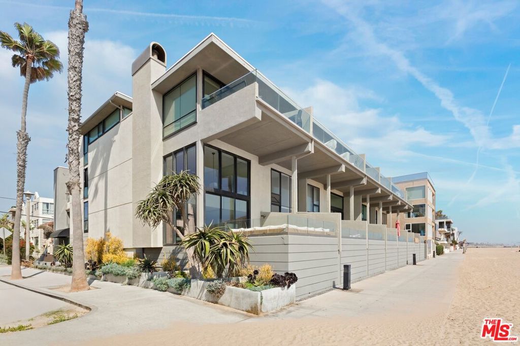Wake up to the rhythm of the waves and end your day with the sun melting into the Pacific. This rare, corner-unit midcentury modern retreat offers direct access to the sand just step off your private deck and you're on the beach. Originally designed by acclaimed AIA architect Anthony Greenberg, this two-bedroom, two-bathroom residence embodies effortless California coastal living with a legacy of design pedigree. Floor-to-ceiling glass walls invite in uninterrupted ocean views stretching from Catalina to Malibu, while natural light floods the open living spaces throughout the day. Whether you're entertaining or unwinding, the open-concept kitchen with sleek stainless appliances flows beautifully into a spacious living area with fireplace perfect for cool ocean evenings. The serene primary suite offers ocean views from bed, custom closets, and a spa-like en-suite bath. A second bedroom, stylish guest bath, and a private deck with lounge seating make this home as functional as it is beautiful. Step out your door to stroll along the beach, walk to charming local restaurants and boutiques, or explore the scenic Marina paths. And at night, fall asleep to the calming soundtrack of the surf. This is more than a home it's a lifestyle only a select few get to call their own. Iconic. Architectural. Oceanfront. Welcome to your new beach life.
