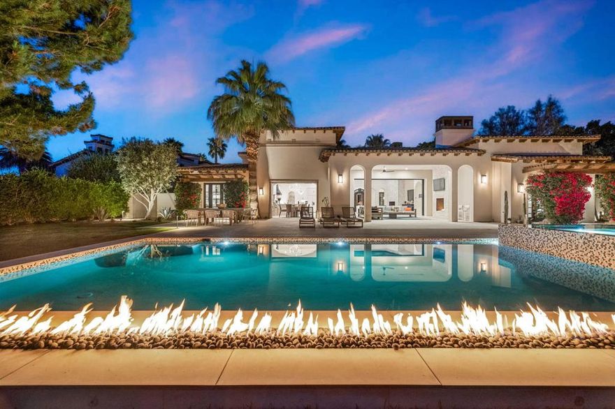 Welcome to one of the most remarkable properties in the prestigious Hideaway community of South La Quinta. Perhaps one of the largest and most private residences in the entire community, this 20K sq ft lot expands into acres of unobstructed southwest facing mountain views. With no other homes in sight from the interior view, this residence provides what is unparalleled privacy that is unique and will remain forever. The property has been transformed by the current owners over the last 12 years, expanding the initial lot through a land purchase from the club in 2014 and then subsequent work over the years has resulted in what can only be described as exposing a previous diamond in the rough. Positioned on the 16th hole of the Clive Clark course, this home is perfectly positioned at the end of a rare single lined cul-de-sac. This 5-bedroom, 5 1/2-bathroom residence all on one floor, features dual master suites, a fully enclosed courtyard entry that sets the tone for the refined living within. The interior showcases timeless architectural details including arched doorways and a modern wood coffered ceiling in the great room.  A recent complete re-model blends classic Hideaway style with a modern flare, the result is a true turnkey opportunity for those looking for something special. Wall-to-wall pocket doors seamlessly connect indoor and outdoor living, leading to a sprawling covered patio with a built-in outdoor grill, firepit, and fireplace. The resort-style backyard is a true desert paradise, featuring a 40 ft pool with an elevated spa and baja shelf that leads to a perfect setting with a special view. The updated rear of the property is accentuated with fire features both at the pool's edge and an elevated outdoor entertaining area with firepit.  Adjacent to the firepit is your own lighted bocce ball court.  The property has a professionally designed outdoor sound system encompassing buried subwoofers and 16 speakers for an unparalleled and private listening experience. 53731 Via Mallorca, a rare and refined offering in one of the desert's most exclusive enclaves--this is Hideaway living at its finest.