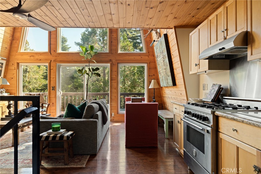 WOW, WOW, WOW!!! Super Cool Cabin with Amazing Views Sitting in the Tops of the Trees! JUST STUNNING!!! You Will Love the Gorgeous Natural Light Streaming in Through the Wall of Windows... You are Surrounded by Tongue & Groove Wood Throughout & the Smell of the Pines & Cedars Will Remind You that You are in the Mountains!! Sit out on the Deck, Bask in the Tranquility and ENJOY THE VIEWS!!! You Can See All the Way to Big Bear!!! Gorgeous Trees All Around!!!! So Lush! Modern Kitchen with Stainless Steel Appliances - Definitely a Rustic Modern Vibe Here! Bedrooms on Each Level Give Everyone Privacy... Lowest Level Bedroom is Currently Being Used as a Den. Natural Landscaping & Beautiful Blooms to Make You Say Wow on Your Way to the Front Door! Newer Build w/LOTS OF PRIVACY on 1/3 Acre!!! Can Come Partially Furnished! Plenty of Space Behind Home to Create a Yard or Additional Patio/Sitting Area! Come & See... You Won't Want to Leave!