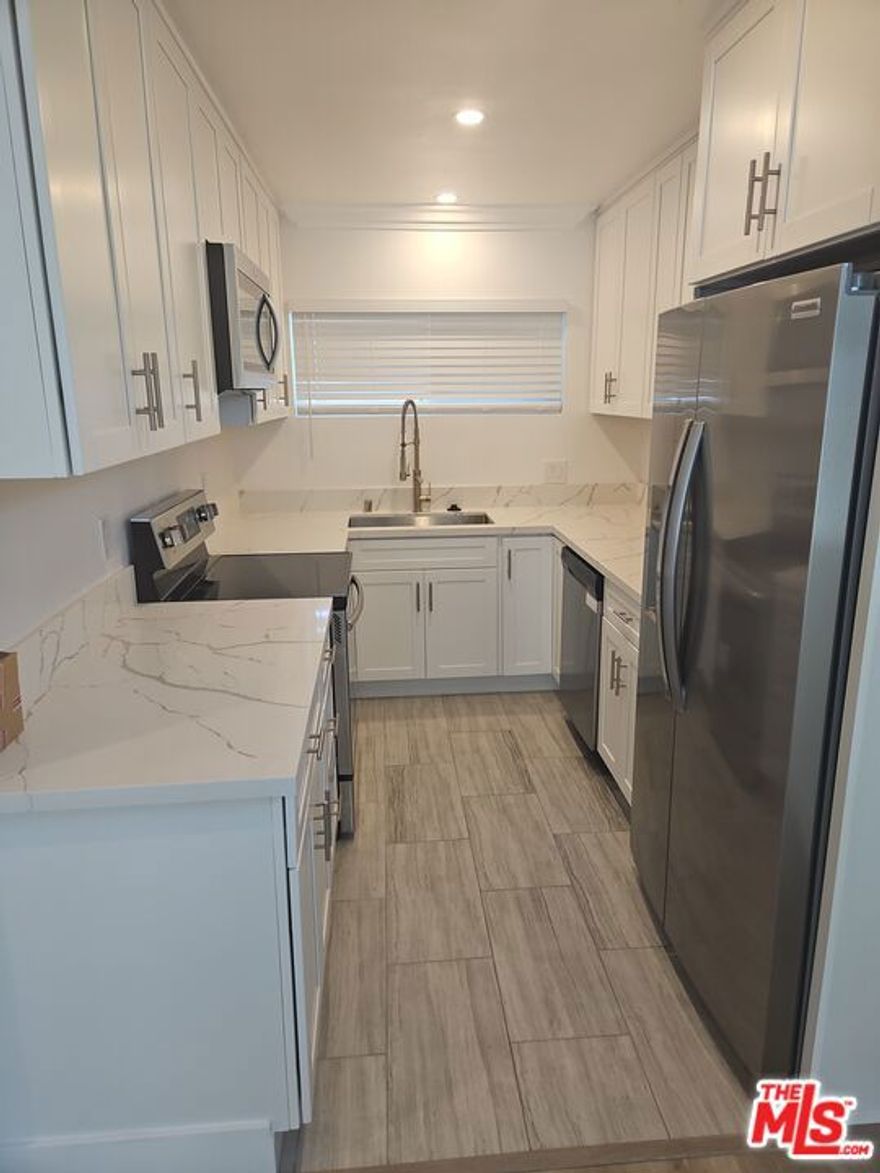 Spacious 1 bedroom 1.5 bath all new and modern finishes.  Great powder bath for guests.  Counter depth refrigerator included for awesome look.  Stainless steel appliances.  Quartz counters.  Tons of closet space.  Huge and newer  windows that slide like a dream.  Tons of natural light.  Great open floor plan between living, dining, den, and kitchen areas.  Just a couple doors down from trendy Montana Ave and a few blocks from the Ocean.   Secure property, with secure covered parking for one car. Intercom at gate calls your phone. Walkable to beach, shopping, farmer's markets, and more. Laundry room on premises (pay with quarters or your phone). Shown by appointment only.