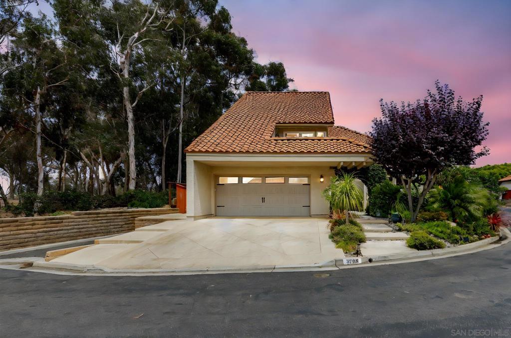 Stunning four bedroom, three bath, garden view remodeled home with extensive upgrades throughout. Gorgeous and expansive updated kitchen with shaker cabinets, quartz countertops and stainless steel appliances. Beautiful open breakfast nook overlooks the private courtyard. Sellers have added over $200,000 in upgrades including newer roof and upgraded plumbing, heating, and air conditioning! Wonderful wine room near entry before you walk into the vaulted living room with a stunning fireplace. Downstairs bedroom and a newly upgraded bathroom with luxury stone vanity and tiled tub/shower. Sliding glass doors lead you out to a beautiful patio with a cozy spa tub. Spacious primary suite with amazing steam shower, dual split quartz vanities, gorgeous new quartz and tile finishes, and large view private balcony. Additional upstairs bath offers upgraded quartz counters and large shower. The picturesque front, side and backyard resemble a relaxing paradise, complete with fountains, flowing ponds and beautiful landscaping. The home is a must see, coastal dream close to shopping, 78 freeway and short bike ride to the beach.