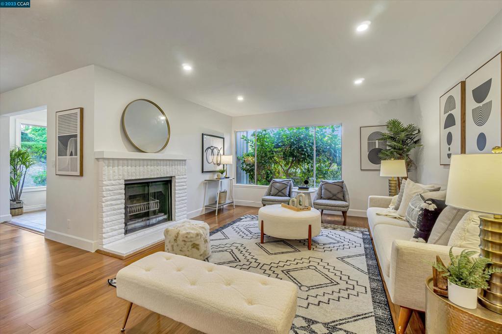 Stunning level-in home in Rossmoor's Mutual 3 with absolutely zero steps! Rarely available corner unit, TAHOE floorplan! Light and bright, offering updated eat-in kitchen, formal dining area, family room, and living room with fireplace. Fresh neutral paint and recessed lighting throughout, hardwood flooring, primary bedroom with 2 closets, remodeled bathroom with dual vanity, and walk in soaking tub! Single car garage with the opportunity for ample storage PLUS covered carport. Walls of windows allow endless amounts of natural light and views of the lush landscaping to be enjoyed. This home is surrounded by beautiful trees, wildlife, and offers convenient outdoor seating in both the front garden patio and back patio area. Fantastic floorplan with full washer and dryer in laundry room and even more storage! Two large sliders connect indoor/outdoor to the large, enclosed patio - perfect for outdoor dining. Newer HVAC too! Rossmoor's amenities include golf, swimming, pickle ball, walking, 200+ clubs and organizations, art studio, ceramics, bridge, dancing, dinners, restaurant, and several clubhouses. Enjoy everything that this premier 55+ gated community has to offer!