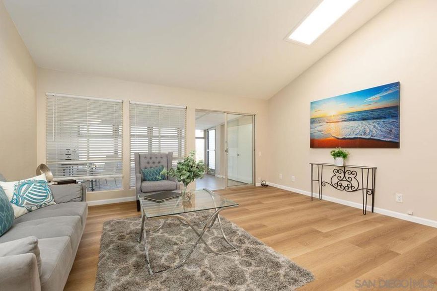 Beautifully remodeled attached home in the highly desirable senior community of Oceana, showcasing expansive, vista views of the mountains. This light-filled end unit has been thoughtfully updated with luxury vinyl plank flooring and fresh designer paint throughout. The open living area flows seamlessly into the bright enclosed sunroom, creating an airy, inviting atmosphere filled with natural light.  The sunroom offers a versatile additional living space, ideal for a home office, craft room, or a relaxing spot to gather with friends while enjoying the views. The upgraded kitchen features soft-close shaker-style cabinetry, granite countertops, and stainless-steel appliances—perfect for both everyday living and entertaining.  The spacious primary suite includes dual closets and a private ensuite bathroom. A second bedroom and full guest bathroom provide comfortable accommodation. Step outside to the rear patio, complete with low-maintenance turf, where you can unwind while taking in the stunning mountain views. Floor plan included in pics, square footage from floor plan  and differs from tax records.  Additional features include a detached one-car garage with ample storage, located just steps away. This move-in-ready home offers a rare opportunity to enjoy resort-style living in one of Oceanside’s most sought-after 55+ communities with a wide array of amenities. See it today.