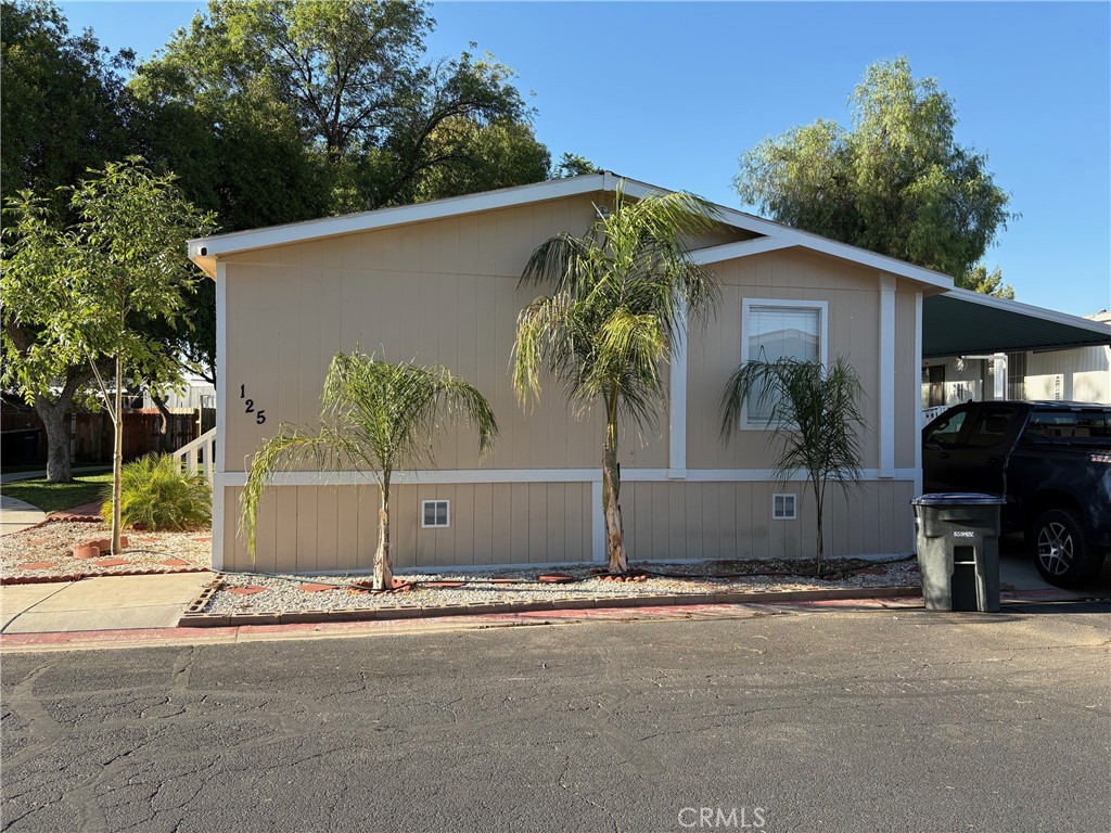 This home offers 1,512 square feet, three bedrooms, two full bathrooms, central air conditioning, central heating, laminated flooring, and additional features. It is located in Lake Perris Village, a gated residential community that is ideal for families.