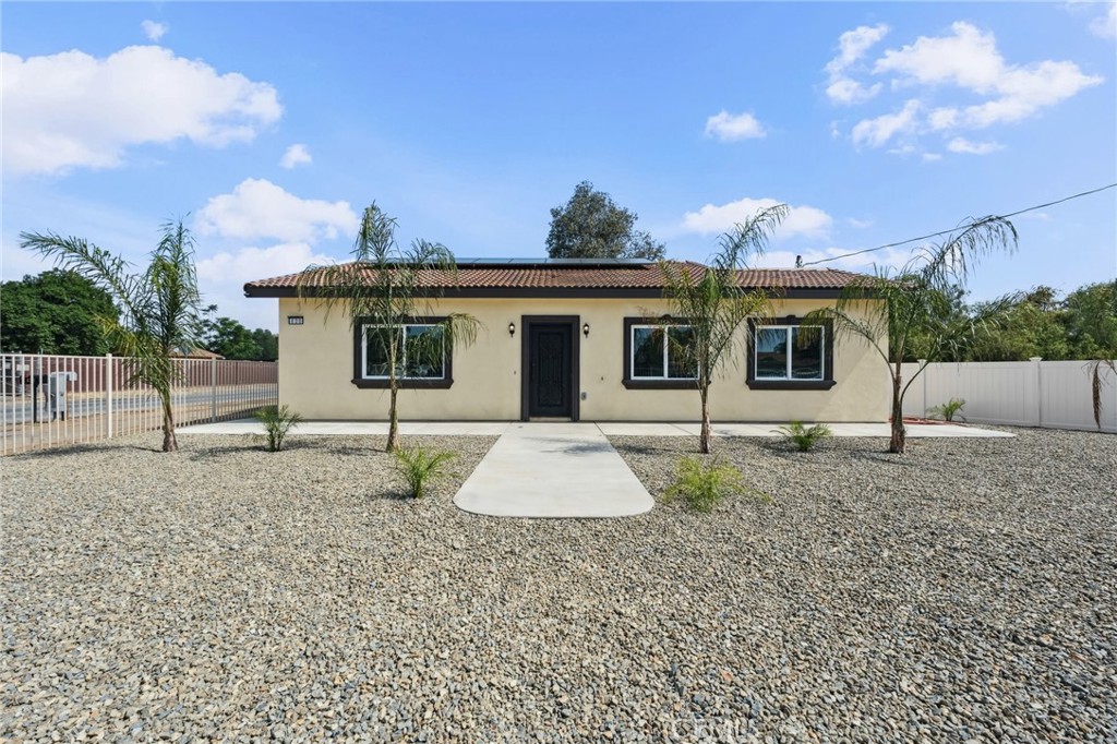 Gorgeous Brand-New Construction on an oversized corner lot! This 3-bedroom, 2-bath home features 1,280 sq ft of stylish living on a massive 18,731 sq ft lot. Step into an open floor plan with 9-ft ceilings, beautiful flooring throughout, and a custom rustic front door that makes a lasting first impression. The spacious kitchen shines with a large picture window, electric 5-burner stove, abundant cabinetry, and modern finishes. Bathrooms include hands-free flush toilets and LED-lit mirrors for a luxe touch. The primary suite offers a walk-in closet, and the dining area opens to the yard via sliding doors—ideal for entertaining. Enjoy drought-tolerant landscaping with palm trees, motorized fencing, an attached 2-car garage with remote, Electric washer and dryer hook ups in the garage. PAID solar panels. Fire sprinkler system throughout the home. Move-in ready with thoughtful upgrades throughout! Close to Elementary school. Valverde District.