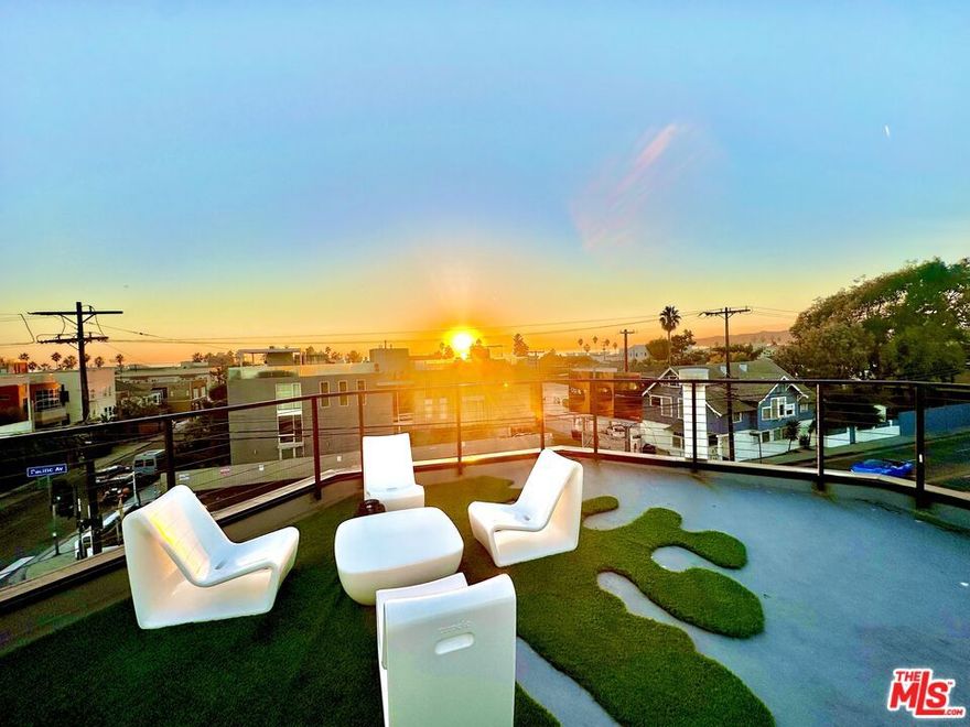 Welcome to a rare fusion of art, architecture, and coastal living. Just moments from the sand and Abbot Kinney Blvd, this exquisitely reimagined residence offers a lifestyle as vibrant as its surroundings. Originally designed by celebrated contemporary artist Martha Alf, the home itself is a work of art. Flooded with natural light through soaring windows and crowned by 30-foot ceilings, the living room evokes the grandeur of a gallery, yet remains warm and livable, a true canvas for your life and your art collection. The chef's kitchen is both a showpiece and a gathering place, with Wolf appliances, Sub-Zero refrigeration, and a striking marble island anchoring the open-concept design. Upstairs, two en-suite bedrooms provide serene retreats, each blending luxury finishes with an effortless sense of calm. On the ground level, a fully self-contained one-bedroom ADU with private entrance offers endless flexibility, perfect for guests, extended family, or creative work. Complete with its own kitchen, walk-in closet, and spa-inspired bath, it mirrors the same level of refinement found throughout the main residence. Indoor and outdoor living flow seamlessly, with glass accordion doors opening onto a private patio and front patio ideal for entertaining. The rooftop terrace crowns the experience, offering panoramic views that stretch from the Pacific Ocean to the city skyline, a breathtaking backdrop for sunset soires or quiet reflection.With an attached two-car garage, dual laundry facilities, and every detail thoughtfully considered, this residence is more than a home, it's the Venice Beach lifestyle.
