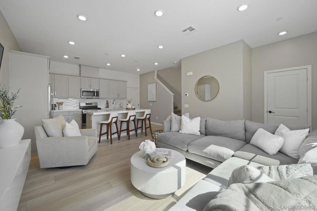 Nearly new 3 bedroom, 2.5 bath townhome in the sought after Bluestone community at Côta?Vera. This home features upgraded luxury vinyl plank flooring, an open concept living and dining area, and a modern kitchen with quartz countertops, stainless steel appliances, and ample cabinet space. The primary suite includes a spa like bath with dual sinks and walk in closet. Additional highlights include a 2 car garage, in unit laundry, and fully paid off solar panels, providing energy savings from day one. Located in a vibrant master planned neighborhood, residents enjoy resort style amenities including a pool, parks, walking paths, and green spaces. Close to newer construction homes, shopping, dining, and top rated schools, this townhome combines modern finishes, sustainable energy features, and functional design. A rare opportunity to own a nearly new home with no solar payments, blending comfort, style, and efficiency in a highly desirable Southern California community.