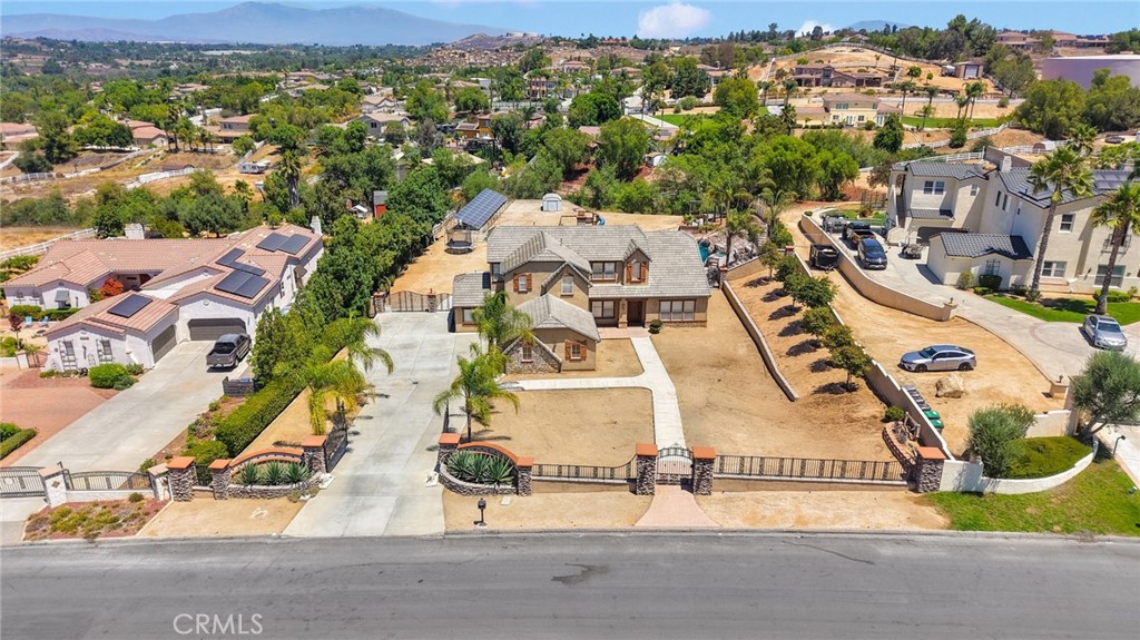 Stunning Gated Estate located in the desirable neighborhood of Mockingbird Canyon. THIS HOME HAS IT ALL! This 4,431 square foot home features 4 bedrooms, each with its own ensuite bathroom, an office that could be your 5th bedroom and a 5th bathroom, fully remodeled kitchen completed with high end appliances and custom features, private 1 bed 1 bath ADU with its own entrance, MASSIVE resort-style pool with beach entry, waterslide, water features, spa, and more, outdoor kitchen, separate outdoor bathroom (7th bathroom), OWNED SOLAR, gated entry, private driveway, 1.23 acres, VIEWS and MORE!!!! Do not miss your opportunity to own this AMAZING ESTATE!