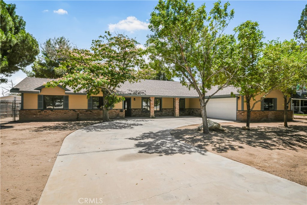 This beautifully upgraded home welcomes you with fresh interior and exterior paint that gives it a crisp, move-in ready feel from the moment you arrive. Step inside to find brand new plank flooring flowing throughout the entire home, paired with new LED light fixtures that brighten every corner. The kitchen is a true standout, featuring custom cabinetry, gleaming granite countertops, a custom tile backsplash, a stainless steel drop-down hood, and matching stainless steel appliances, including a sleek sink. A dine-in kitchen area is accented by a rustic custom wood beam, adding warmth and charm. Enjoy two separate living areas and a formal dining space, plus a cozy breakfast nook—perfect for everyday living or entertaining. The expansive master suite includes a walk-in closet with custom storage, a private slider to the backyard, and a spa-like ensuite with a luxurious separate soaking tub and tiled shower, all complemented by custom cabinets and granite tops. The guest bathroom is equally impressive, with a custom-tiled shower and floor, granite-topped vanity, and elegant finishes. The entire property sits on a fully flat and usable oversized lot, offering RV access and a fully fenced backyard shaded by mature trees. Both the front and back yards boast covered patios, ideal for relaxing and enjoying the serene setting. Located on a desirable larger lot with central heat and air and an oversized 2-car garage, this is a rare offering in an excellent location. Come see this stunning property for yourself before it’s gone!