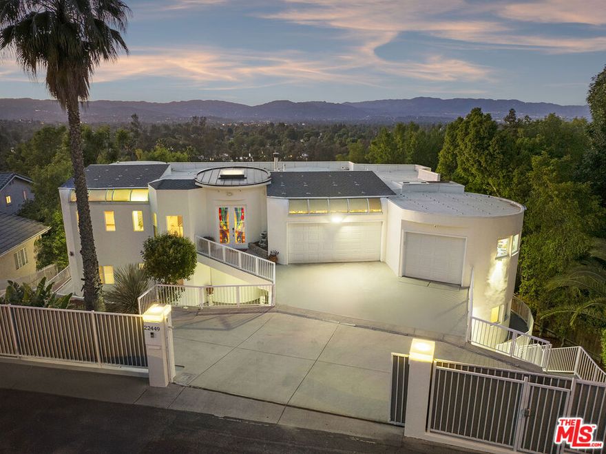 A rare opportunity to own one of Woodland Hills' most expansive luxury estates. Spanning over 6,100 sq ft of living space on a serene tree-lined street south of the Boulevard, this architectural residence offers 9 bedrooms, 10 bathrooms, and panoramic mountain views. The main home showcases an open-flow design with grand entertaining spaces, soaring ceilings, and custom finishes throughout. Natural light pours into multiple living areas, seamlessly connecting to outdoor terraces framed by mature landscaping. In addition to the primary residence, the property is thoughtfully configured with several private guest suites, each with its own kitchenette and private entrance. These versatile spaces are ideal for extended family, live-in staff, creative studios, or income-producing lodgers-giving future owners both lifestyle flexibility and the ability to significantly offset monthly costs while enjoying the estate's grandeur. Set on nearly a 14,000 sq ft lot, the grounds offer privacy, room to expand, and potential for further development under California's SB9 guidelines (buyer to verify). This estate is truly a blend of luxury living and financial flexibility, offering unmatched possibilities in one of Woodland Hills' most desirable neighborhoods.