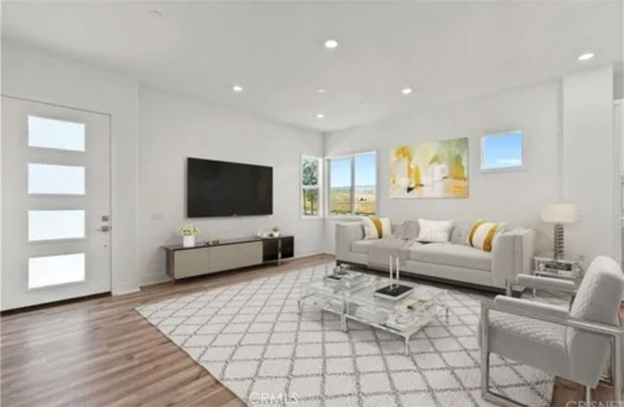 Welcome to modern luxury in the heart of Five Point Valencia. This stunning Lennar Rosemist Plan 4, the largest and most desirable model in the community, was completed a couple years ago and offers the perfect blend of sophistication, comfort, and style. With five bedrooms, four and a half bathrooms, and three spacious levels, this home showcases impeccable design and attention to detail. The main floor features an open-concept, dining area, and chef’s kitchen with a large quartz-topped island, professional-grade stainless steel appliances, and a six-burner cooktop with designer hood. Ten-foot ceilings and wood-like LVP flooring create a sense of warmth and grandeur throughout. A guest bedroom with a full bath on the first floor provides flexibility for visitors, extended family, or a home office. Upstairs, the luxurious primary suite offers a peaceful retreat with a spacious walk-in closet, dual vanities, soaking tub, and separate shower, while three additional bedrooms, two more baths, and a laundry room complete the second floor. The top level is a versatile bonus/loft area featuring its own bathroom, wine fridge, counter space, and a covered terrace with panoramic views of the Santa Clarita Valley—perfect for a game room, gym, or lounge. Enjoy year-round outdoor living with a gated backyard and covered patio ideal for dining or relaxing. Located within the vibrant Five Point community, residents have access to world-class amenities including three pools, a spa, BBQ areas, playgrounds, scenic greenbelts, and a resort-style clubhouse. Conveniently close to shopping, restaurants, top-rated schools, Magic Mountain, and freeway access, this like-new home offers the best of modern design and community living in one of Valencia’s most desirable neighborhoods.