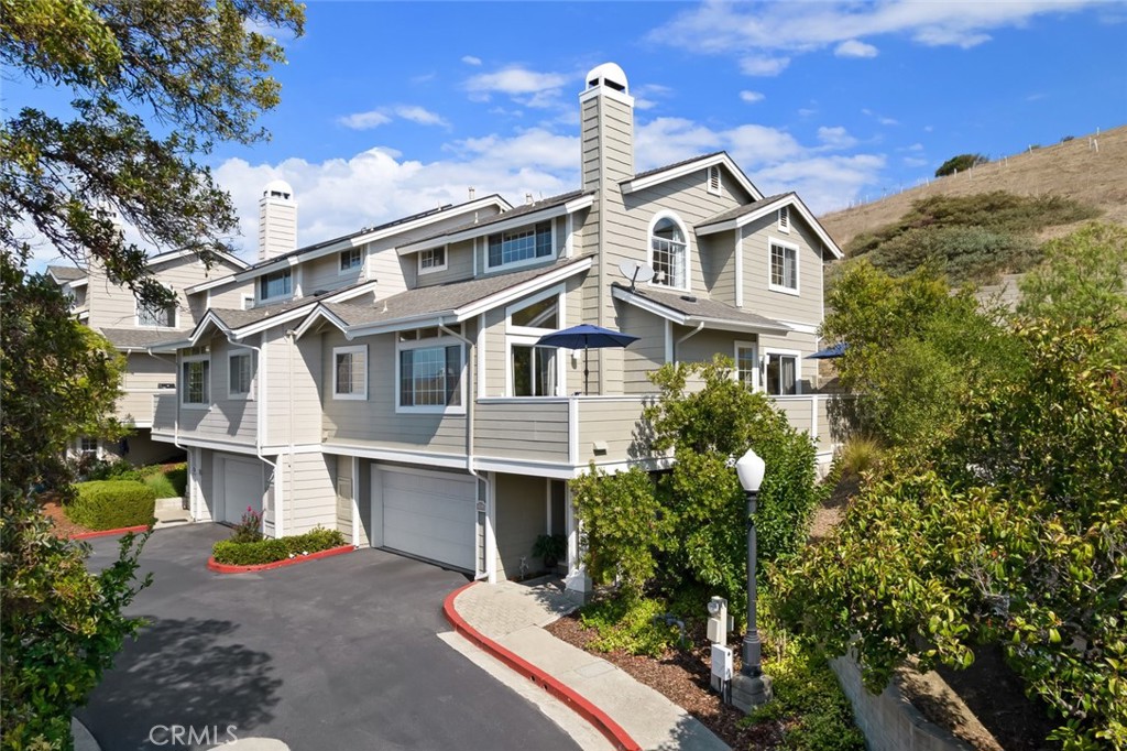 Hillside living at its finest in San Luis Obispo’s coveted Banana Belt! This 3 bedroom, 3 bath home offers city and hillside views from nearly every room. The bright, open floor plan features vaulted ceilings and a fireplace in the living room that flows seamlessly into the dining area and spacious kitchen, complete with recessed lighting, decorative fixtures, and fresh paint. The lower-level bedroom with French doors provides flexible space for a home office, guest suite, or family room, with convenient access to a full hall bathroom. Both the living room and lower-level bedroom open to the wrap-around deck, perfect for enjoying the peaceful Terrace Hill backdrop. Upstairs, the two bedrooms include the primary suite, featuring a vaulted ceiling, two closets, built-in storage, and a double vanity, while the second bedroom has easy access to the full hallway bath. Both rooms boast expansive views of the city and open-space hillside. Laundry is conveniently located upstairs. Set in a private, serene location, the home includes a spacious 2-car garage plus an additional designated parking space. Just minutes from downtown, enjoy easy access to shops, restaurants, parks, schools, hiking and biking trails, French Hospital, and a direct walk or bike ride across the Jennifer Street Bridge. A rare opportunity to own a beautifully maintained home with exceptional views, combining privacy, comfort, and the very best of Central Coast living.
