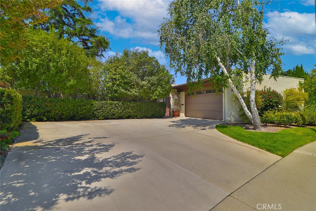 Welcome to this incredible home in the heart of Thousand Oaks West—a truly one-of-a-kind property with plenty of special touches. It features a separate downstairs unit with its own entrance, making it perfect for guests, family, or rental opportunities. The downstairs has a spacious bedroom, a large living area with a cozy fireplace, a bathroom, a washer and dryer room, and a big yard with breathtaking views.
Step through the tranquil courtyard to access the private two-car garage. When you walk in the front door, you’re greeted by walls of glass that showcase stunning nearby vistas. Recently painted with fresh white walls and soaring ceilings, the main level feels open and inviting, with a vaulted beamed ceiling, a warm fireplace, and a lovely balcony off the living room—great for relaxing or entertaining.
The remodeled eat-in kitchen is bright and welcoming, opening to the family room via elegant French doors that lead out to a patio with spectacular views. The primary bedroom has gorgeous views, built-in cabinetry, and a private en-suite bath. The secondary bedroom includes a built-in office system, a walk-in closet, and a large bathroom with a spa tub—perfect for relaxing after a long day.
This home is filled with natural light, feels airy and open, and is move-in ready. It’s a fantastic opportunity to enjoy the incredible lifestyle of Thousand Oaks West in a truly special home.