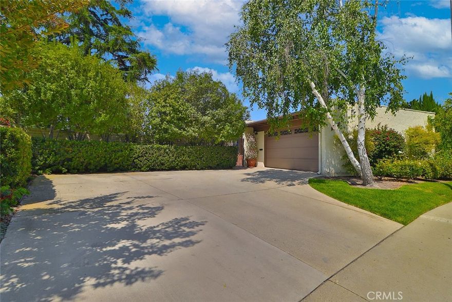 Welcome to this incredible home in the heart of Thousand Oaks West—a truly one-of-a-kind property with plenty of special touches. It features a separate downstairs unit with its own entrance, making it perfect for guests, family, or rental opportunities. The downstairs has a spacious bedroom, a large living area with a cozy fireplace, a bathroom, a washer and dryer room, and a big yard with breathtaking views.

Step through the tranquil courtyard to access the private two-car garage. When you walk in the front door, you’re greeted by walls of glass that showcase stunning nearby vistas. Recently painted with fresh white walls and soaring ceilings, the main level feels open and inviting, with a vaulted beamed ceiling, a warm fireplace, and a lovely balcony off the living room—great for relaxing or entertaining.

The remodeled eat-in kitchen is bright and welcoming, opening to the family room via elegant French doors that lead out to a patio with spectacular views. The primary bedroom has gorgeous views, built-in cabinetry, and a private en-suite bath. The secondary bedroom includes a built-in office system, a walk-in closet, and a large bathroom with a spa tub—perfect for relaxing after a long day.

This home is filled with natural light, feels airy and open, and is move-in ready. It’s a fantastic opportunity to enjoy the incredible lifestyle of Thousand Oaks West in a truly special home.