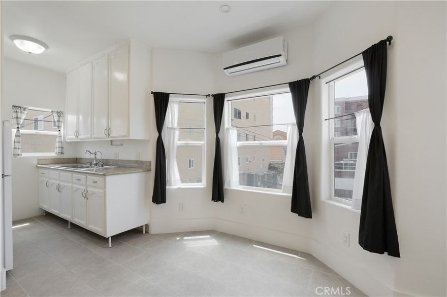 Experience urban living at its finest in this stylish studio condo! Enjoy mini-split A/C and heat, all-tile flooring, and soaring nine-foot ceilings that enhance the spacious feel. The cleverly designed Murphy bed with storage cubbies and eight-foot built-in bookcase provide ample vertical storage, complemented by extra-tall kitchen cabinets. Stay connected with abundant electrical outlets, including high mounts for wall-mounted TVs.



Relish peek-a-boo views of the World Trade Center, City Hall, and the historic First Congregational Church of Long Beach from your bay window, which invites refreshing ocean breezes thanks to no adjacent buildings. This walker's paradise is just 0.2 miles from the vibrant Pine Avenue's eateries, retail, and nightlife, and about half a mile to the Aquarium of the Pacific, Shoreline Aquatic Park, and Downtown Transit Center. The Pacific Light Rail Station (to DTLA Union Station) is also a mere 0.2 miles away. Enjoy peace of mind in a secure building with HOA dues covering water, hot water, and natural gas.