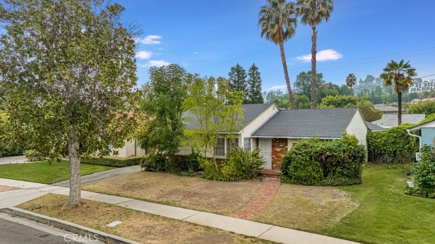 Rare and highly desirable, 3 bed, 2 bath, 1422 sq ft pool home, south of the Boulevard, ready for its facelift! Great value for location! The is the perfect opportunity for those eager to reimagine, renovate, and create their own custom retreat in one of the most coveted neighborhoods in the Valley. Preserve the mid-century charm of this 1950’s home and embrace the opportunity to customize and modernize it to your needs and sensibilities! Great potential for curb appeal with vintage touches like wood siding and weathered brick wainscotting and porch. Inside, a formal tile-floored entry opens into a spacious living room with parquet floors, abundant windows, and a French door opening to the backyard. The kitchen offers a neutral canvas with plenty of possibilities to design and create the true heart of your home. Down the hall is a generous dedicated utility room with laundry facilities and a large, airy living space with brick fireplace, vaulted, beamed ceilings, and plenty of natural light offering wonderful versatility of use. The primary suite offers a wonderful merging of space and privacy, with a large front window with appealing window seat, and en-suite ¾ bath with large walk-in closet and vintage flair. At the other end of the house are two additional good-sized bedrooms which share a ¾ hall bath.  Outside is a generous patio area, lined by brick planters, towering palm trees, and an in-ground pool, anchoring the vibrant outdoor living space awaiting your vision. A large detached two-car garage with an adjacent workshop offers incredible potential for an ADU conversion, studio, or creative workspace. Well situated in a quiet residential neighborhood but near to all the excitement of shopping, dining, entertainment and recreation on Ventura Blvd, or the natural beauty of the mountains to the south.  Bursting with possibilities, this south-of-the-Boulevard gem invites you to bring your imagination, design flair, and vision to craft a home that’s uniquely yours in one of the Valley’s most desirable locations.  Don’t let this one pass you by!