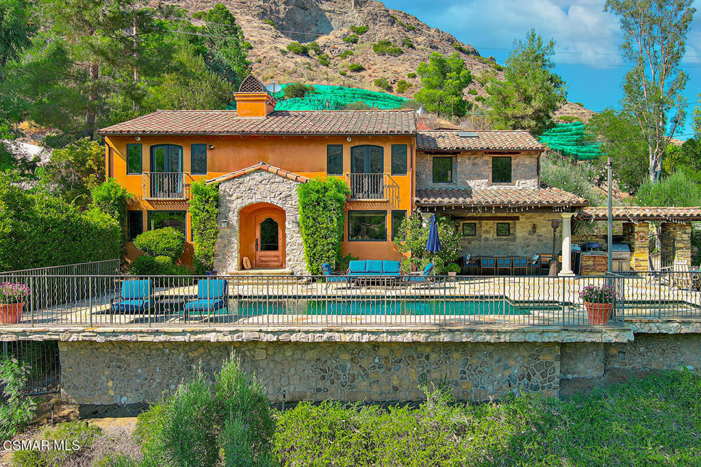Exclusive Italian style vineyard estate with stunning Mountain Views in the Santa Monica mountains of Agoura.Nestled in the heart of nature's beauty, this enchanting, approximately 12 acre vineyard estate offers an unparalleled blend of luxury, privacy and serene elegance. With an impressive waterfall entry and panoramic mountain views, the property invites you to experience the ultimate in vineyard living. This property is beautifully planted with premium Merlot, Cabernet and Syrah vines, along with lush fruit trees, including olive, and guava pineapple, all set against the backdrop of breathtaking scenery. The boutique vineyard has produced multiple award winning wines and high ratings from wine enthusiasts.Entertain in style with multiple outdoor spaces designed for relaxation and enjoyment, including a custom barbecue, a large putting green perfect for the golf enthusiast and a sparkling pool and spa.The outdoor stone fireplace is the perfect touch for cozy evenings while the expertly landscaped grounds provide a peaceful sanctuary to unwind.Inside, the 3 bed, 3 bath plus bonus room home boasts timeless hardwood floors, 2 fireplaces and a spacious open concept layout that seamlessly connects the living and dining areas. The gourmet kitchen is designed for the home chef, offering premium finishes, an 8 burner newer Wolf range with a pasta arm above, a Sub Zero refrigerator, a built in wine/ beverage refrigerator and gorgeous marble countertops. It's the perfect space for culinary creativity.Enjoy the convenience of an upstairs laundry room and take advantage of the versatile upstairs bonus room, ideal as a media room, office or extra living space.For the creative soul, the separate air conditioned artist retreat offers an inspiring and tranquil space to create with an abundance of natural light. Additional features include ample parking as well as a two car garage, and a dedicated shed for outside storage.Whether you're relaxing by the pool, playing on your private putting green, or savoring a glass of wine overlooking the majestic mountains , this estate offers the perfect balance of luxury, tranquility and breathtaking beauty.Come experience the magic - schedule your private tour today!